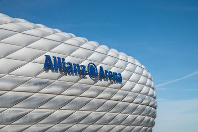 Low angle view of text against blue sky