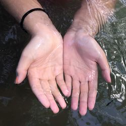Low section of woman with reflection in water