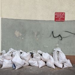 Garbage bin against wall in city