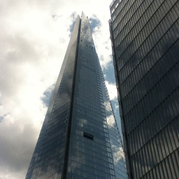 architecture, built structure, building exterior, modern, skyscraper, low angle view, office building, tall - high, city, tower, sky, glass - material, reflection, cloud - sky, building, tall, cloud, day, office block, outdoors