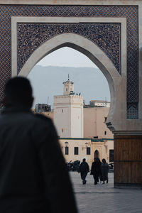 Rear view of man standing in historic building