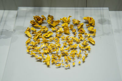 High angle view of yellow flowers on table