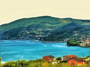 Scenic view of sea and buildings against sky