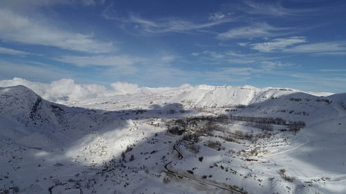 Scenic view of snow covered mountains against sky