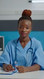 Portrait of smiling female doctor working at clinic