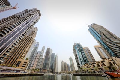 Low angle view of buildings in city against clear sky