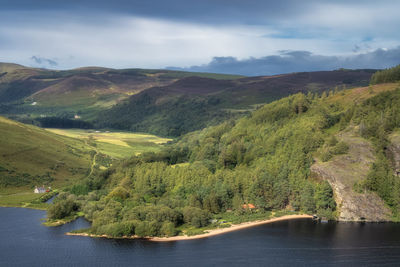 Panorama with houses, lake, beach, forest and mountains. lough dan in wicklow mountains, ireland