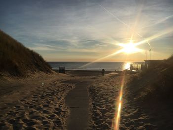 Scenic view of beach against sky during sunset