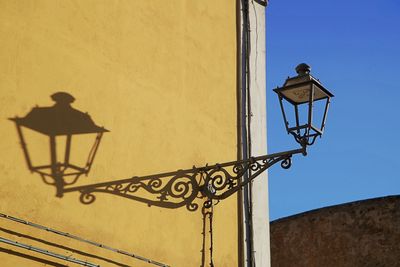 Low angle view of street light against building