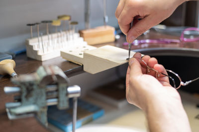 Cropped hands of man working at workshop