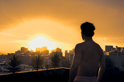 Silhouette man standing against sky during sunset