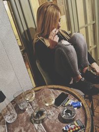 High angle view of woman sitting in glass