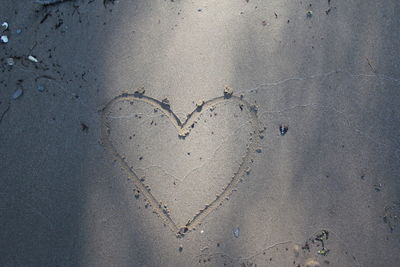 Directly above shot of heart shape on sand