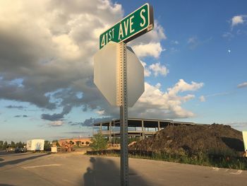 Road sign against sky