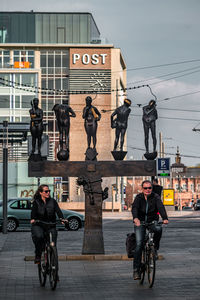 Man riding bicycle on street in city