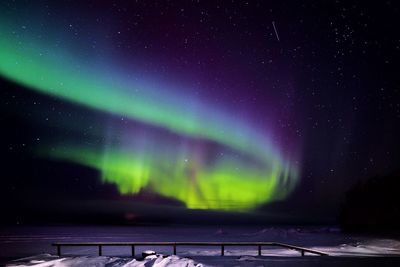 Scenic view of lake against sky at night