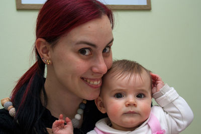 Portrait of mother with baby at home