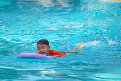 Boy swimming in pool