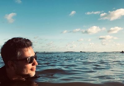 Portrait of man in sunglasses against sky