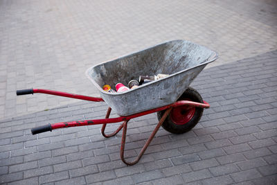 High angle view of wheelbarrow with garbage on street