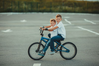 Rear view of boy riding bicycle