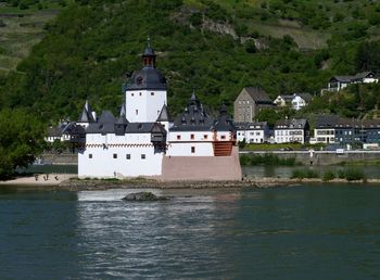 Building by sea against mountain