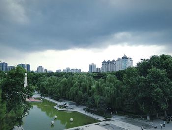 Bridge over river against cloudy sky