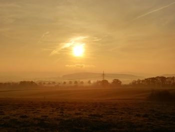 Scenic view of field against sky during sunset