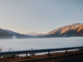 Scenic view of bridge over mountains against sky