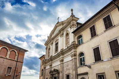 Low angle view of building against cloudy sky