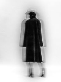 Rear view of man standing against wall