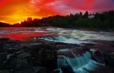 Scenic view of river against sky during sunset