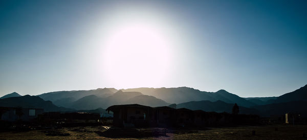 Scenic view of silhouette mountains against clear sky