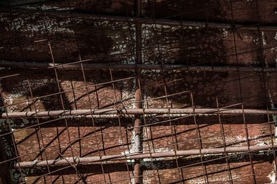 Man standing by metal structure