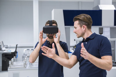 Two men in testing instrument room with vr glasses