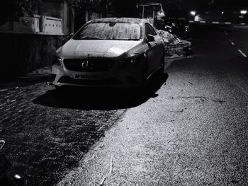 Rear view of car parked on road at night