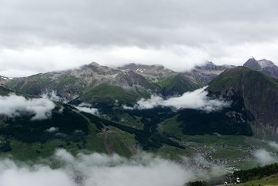 Scenic view of mountains against cloudy sky
