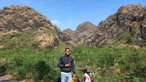 Portrait of young man standing on mountain