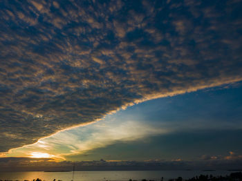 Low angle view of storm clouds in sky during sunset