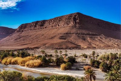 Scenic view of desert against blue sky