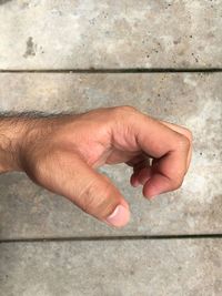 Close-up of man hand gesturing against wall