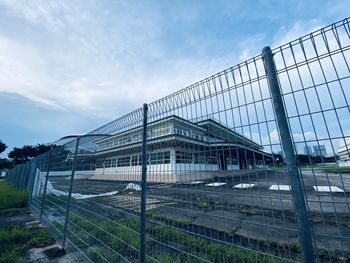 Low angle view of greenhouse against sky