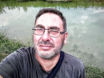 Portrait of man with reflection in water