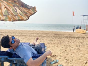 Portrait of man relaxing on beach