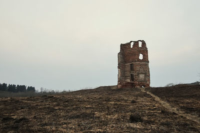 Old building on field against clear sky