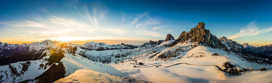 Snowcapped mountains against sky during sunset