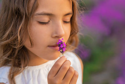 Cute girl smelling flowers at farm