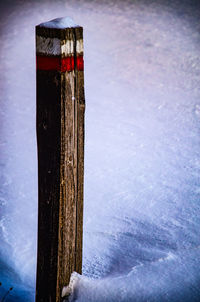Close-up of snow on wood during winter