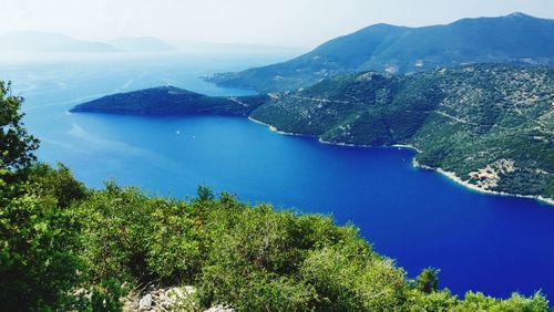 High angle view of sea and mountains against sky