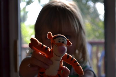 Close-up of woman holding toy at home